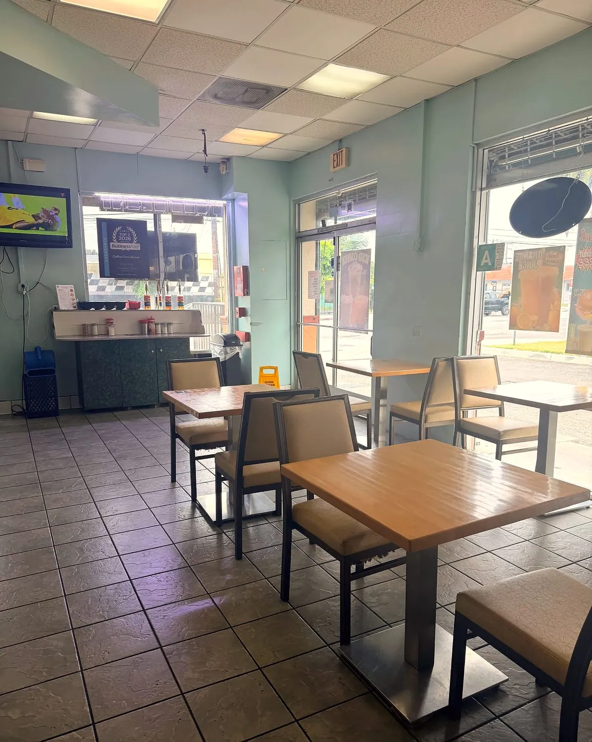 Inside Coffee Time Donuts — tables by the front windows